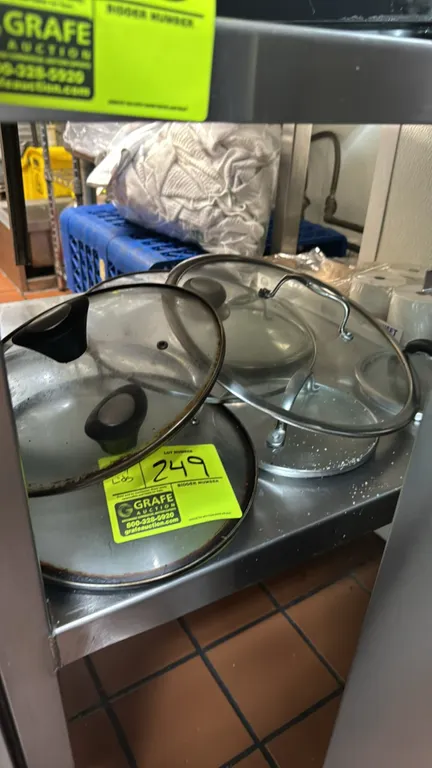 Package lot of assorted glass pot and pan lids. Includes various sizes featuring tempered glass construction with stainless steel rims, steam vents, a