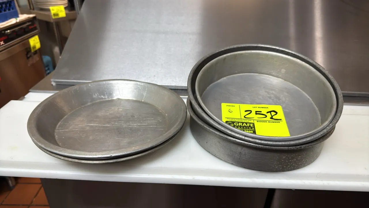 Aluminum pie and cake pans. Features aluminum construction. Includes round cake pans and sloped pie pans. 9"Dia.