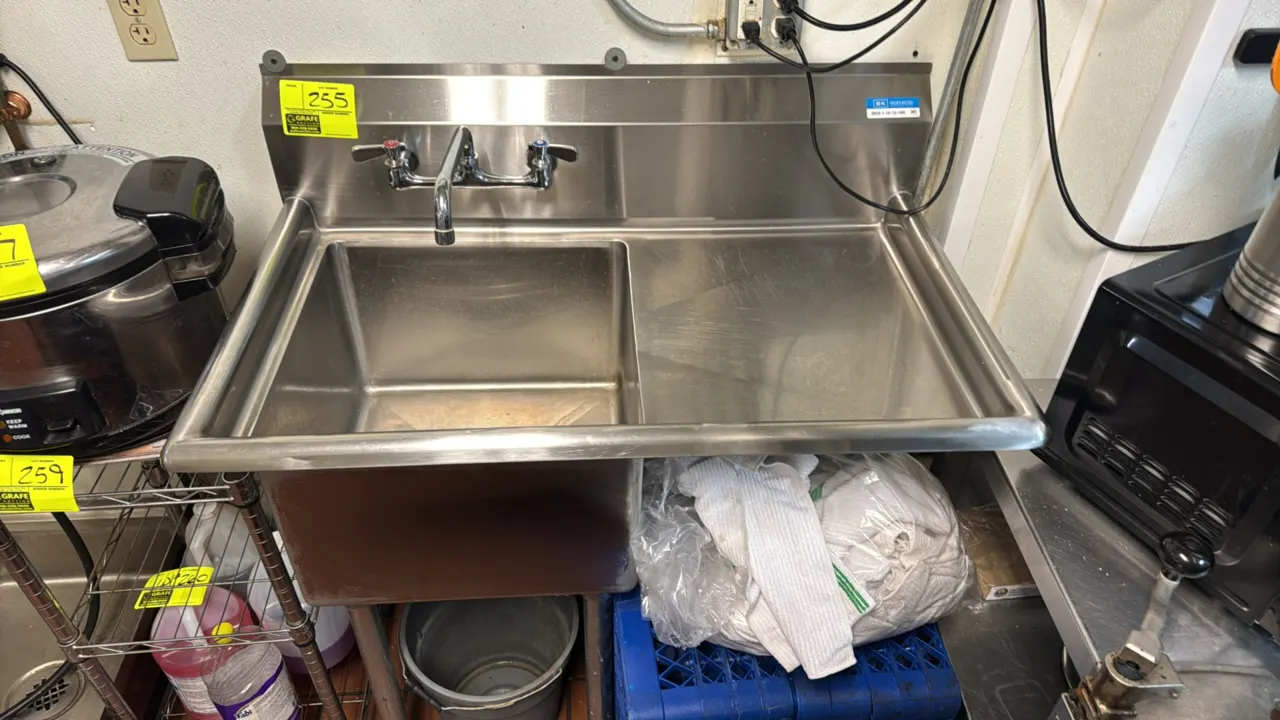BK Resources stainless steel single compartment sink. Features a right-side drainboard, backsplash, splash-mount faucet with swing spout, and stainles