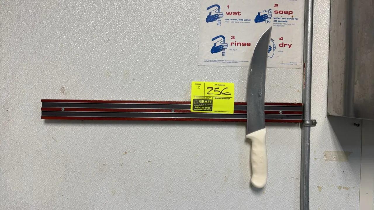 Winco Stal 9 1/2" knife with 24" magnetic knife rack. Knife features a curved German steel blade with NSF certification and a textured white handle. P