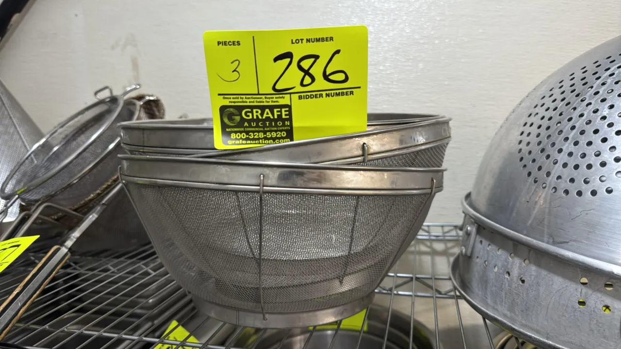 Stainless steel mesh strainers. Features fine wire mesh construction, solid top rim, wire support framing, and integrated foot ring base. Measures 12"