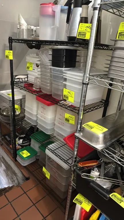 Coated metal 4-tier wire shelving rack. Features black finish with 4 wire shelves. Dimensions: 36" x 14" x 55". Contents not included.