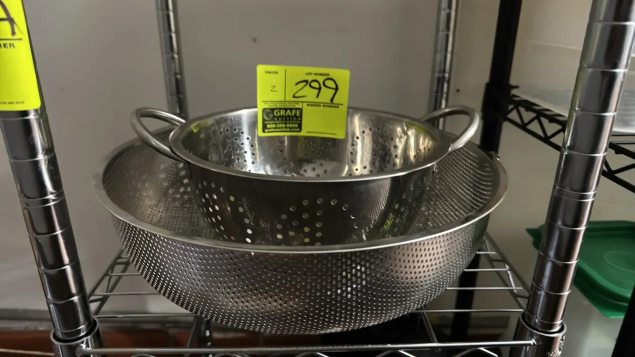 Stainless steel strainers. Features perforated stainless steel construction, with one unit including dual side loop handles and a footed base. Dimensi