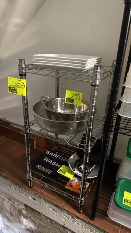 Chrome 3-tier wire rack. Features (3) wire shelves. 15" x 14" x 31". Mounted on adjustable leveling feet. Contents not included.