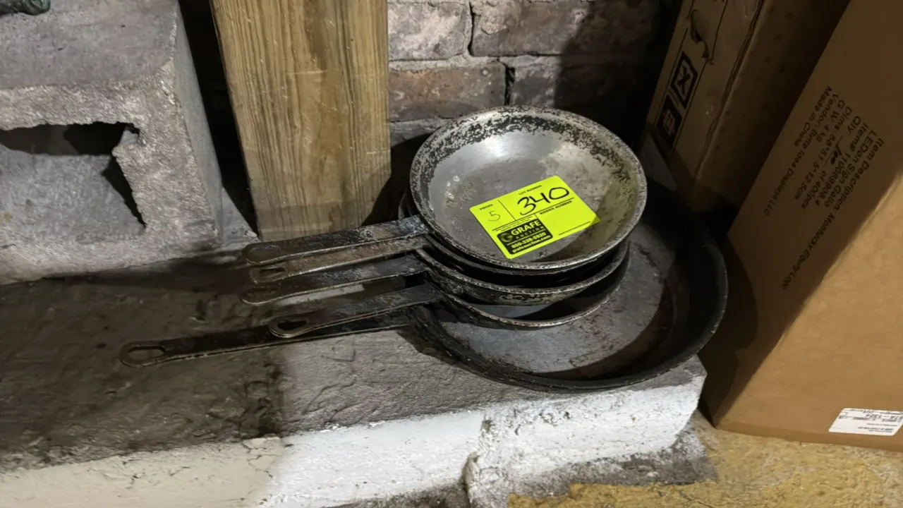 Aluminum frying pans. Features riveted flat metal handles with hanging holes. Includes (1) 12" pan and (4) 8" pans.