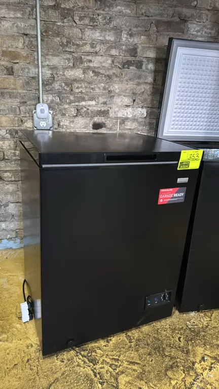 2024 Frigidaire Gallery FGFRF5009-BLACK chest freezer. Features garage-ready design, top-opening lid, removable interior wire basket, mechanical tempe