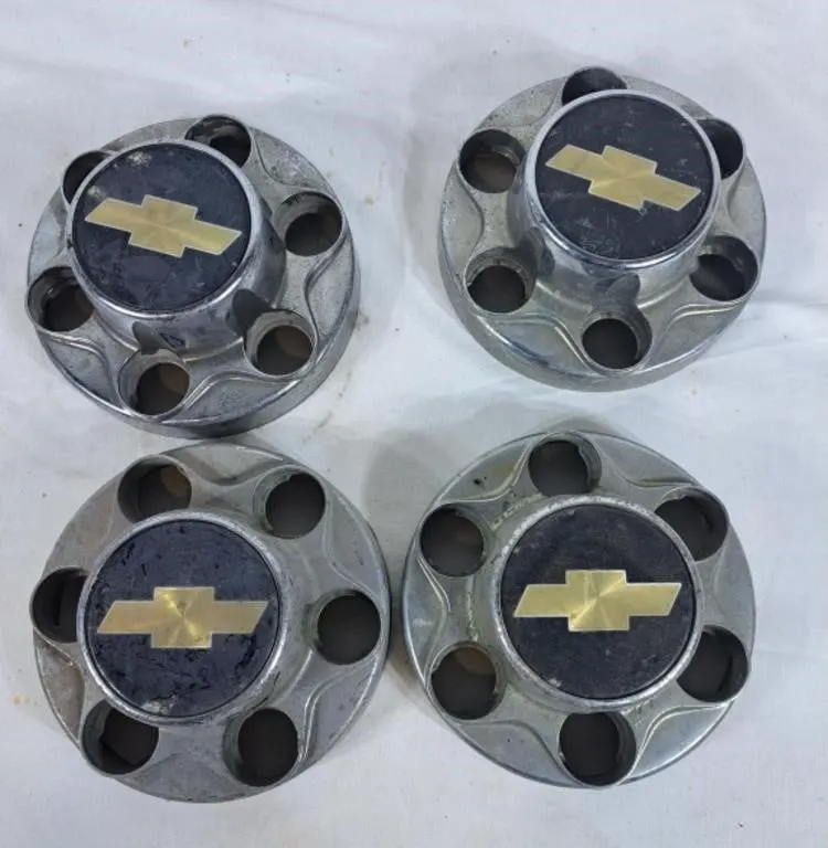 Four Chevy Hub Caps With 25 Plastic Lug Caps