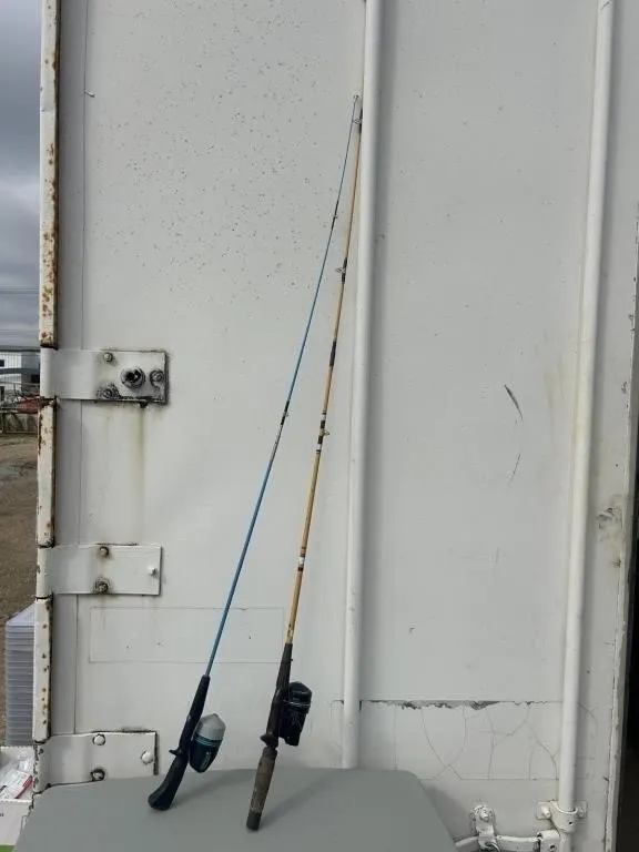 Two vintage spinning fishing rods with reels