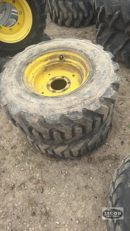 Pair of 300/70R16.5 tires on Jd 6 bolt wheels