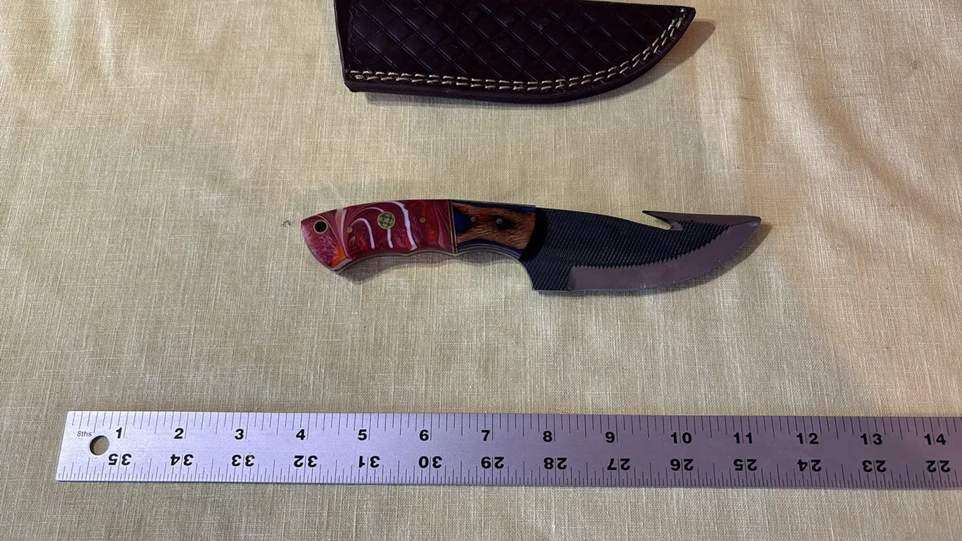 Damascus steel knife with gut hook