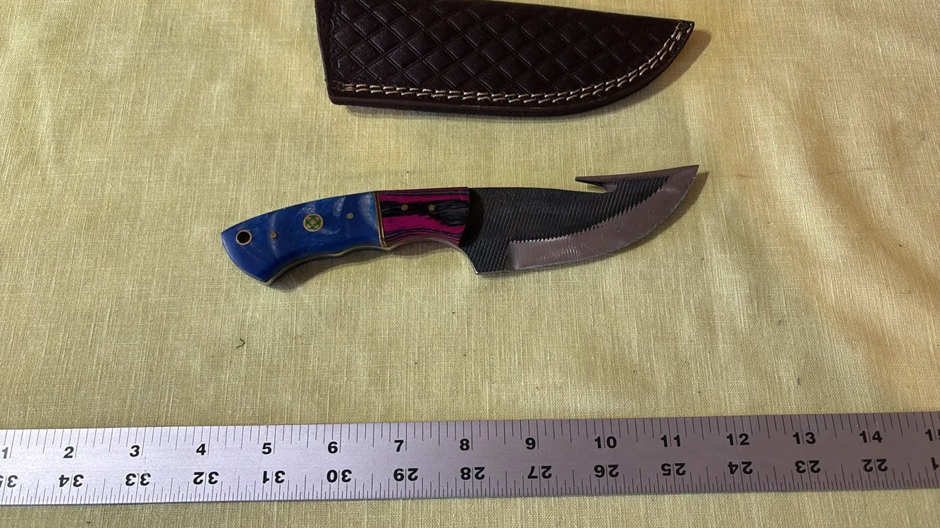 Damascus steel knife with gut hook