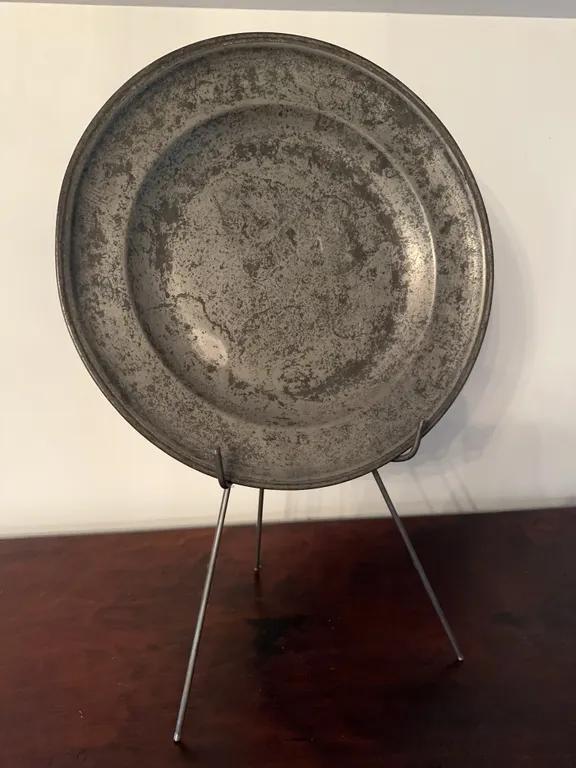 Large hammered metal plate on stand