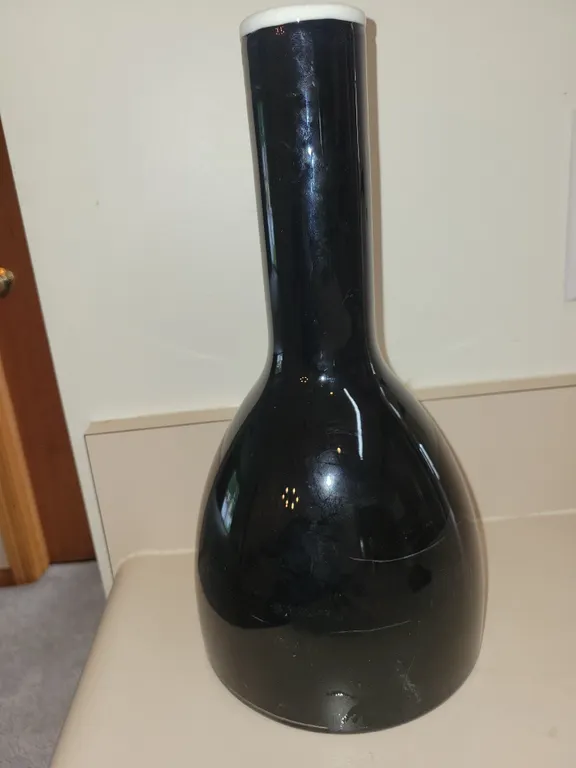 **RARE***Tall, hand-blown black glass bottle vase with a bulbous bottom, a long slender neck, and a