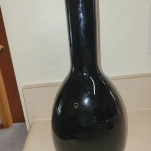 **RARE***Tall, hand-blown black glass bottle vase with a bulbous bottom, a long slender neck, and a