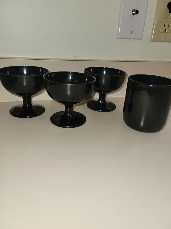 3 vintage black glass champagne coupes or sherbet glasses featuring a short pedestal stem and a wide
