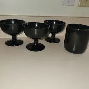 3 vintage black glass champagne coupes or sherbet glasses featuring a short pedestal stem and a wide