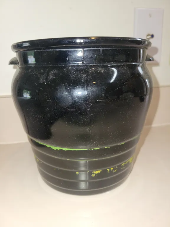 vintage black-glazed ceramic or glass barrel-style crock or biscuit jar, featuring two small side ha