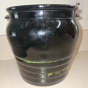 vintage black-glazed ceramic or glass barrel-style crock or biscuit jar, featuring two small side ha