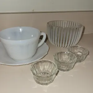 3 glass salt dishes, 1 glass dish, 1 milk glass cup  with small chip on lip and  a saucer.