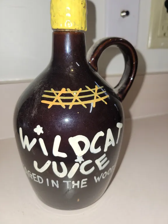 vintage mid-century novelty "Wildcat Juice" ceramic moonshine jug decanter.