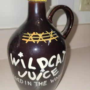 vintage mid-century novelty "Wildcat Juice" ceramic moonshine jug decanter.