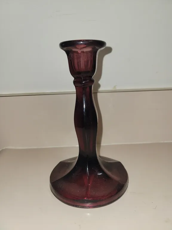 vintage amethyst glass candlestick holder featuring a rich purple hue and a flared, paneled base.