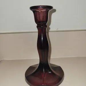 vintage amethyst glass candlestick holder featuring a rich purple hue and a flared, paneled base.
