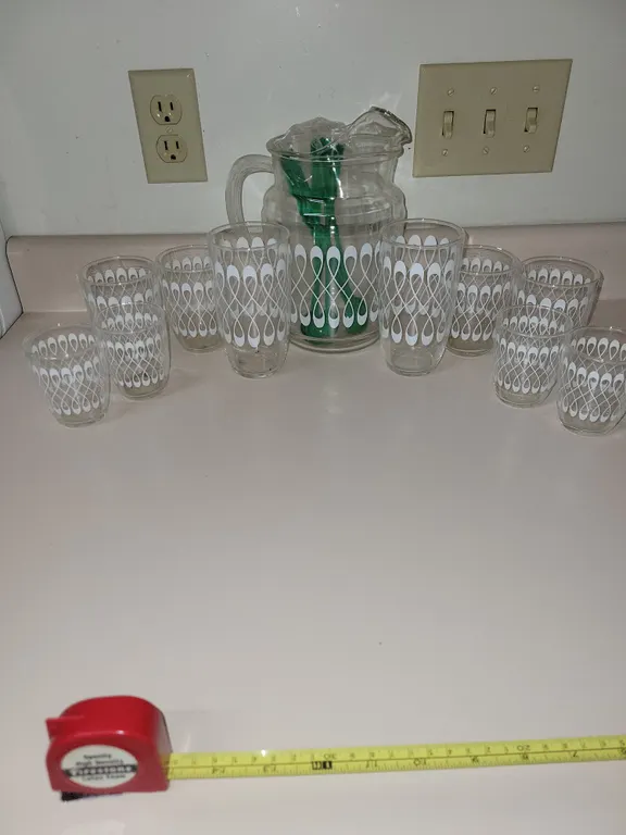 vintage mid-century modern glassware set featuring a matching pitcher and tumblers with a white loop