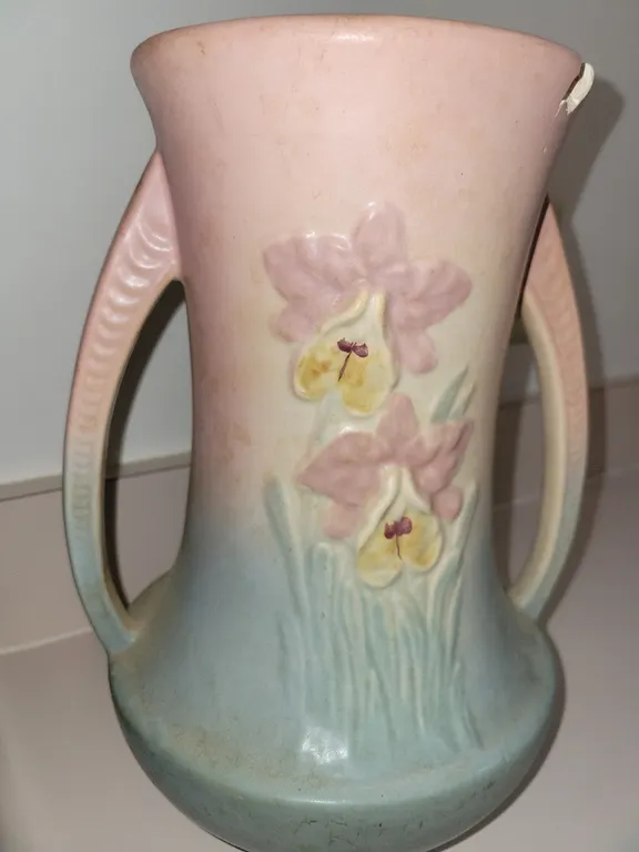 vintage two-handled ceramic vase featuring an embossed pink and yellow orchid design with a matte pi