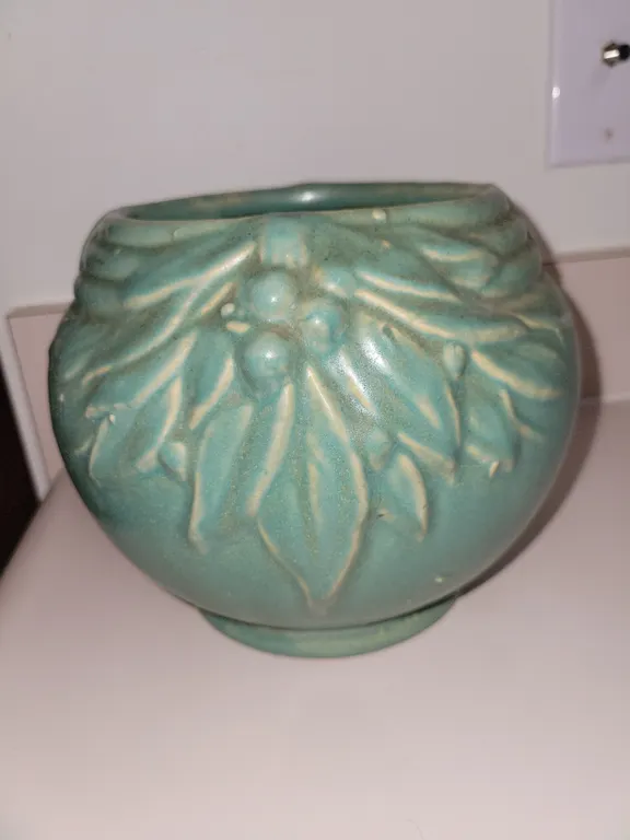 vintage matte green ceramic planter or jardinière featuring an embossed leaves and berries motif, cl