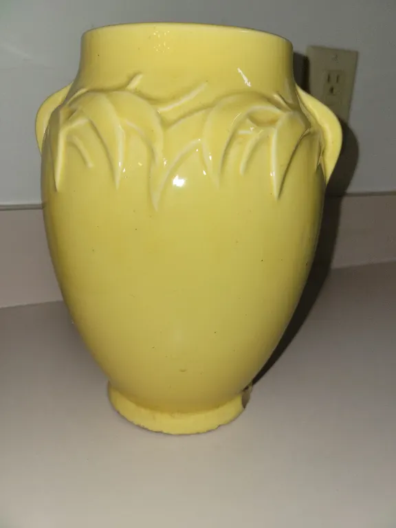 vintage 1940s yellow ceramic vase featuring an embossed leaf and dual handle design, characteristic