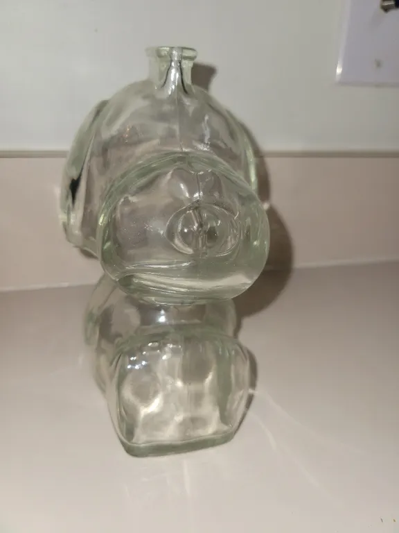 vintage 1966 Anchor Hocking clear molded glass Snoopy piggy bank from the Peanuts comic strip by Cha