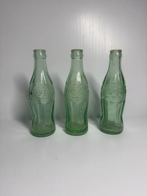 3 Coca-Cola Bottles