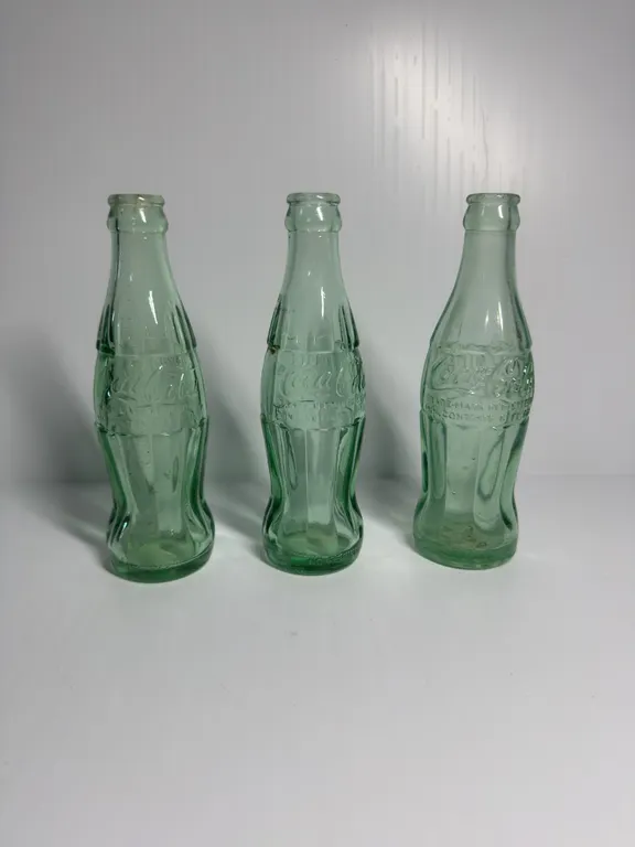 3 Coca-Cola Bottles