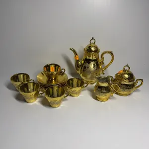 13 piece gold tea set with peacock pattern