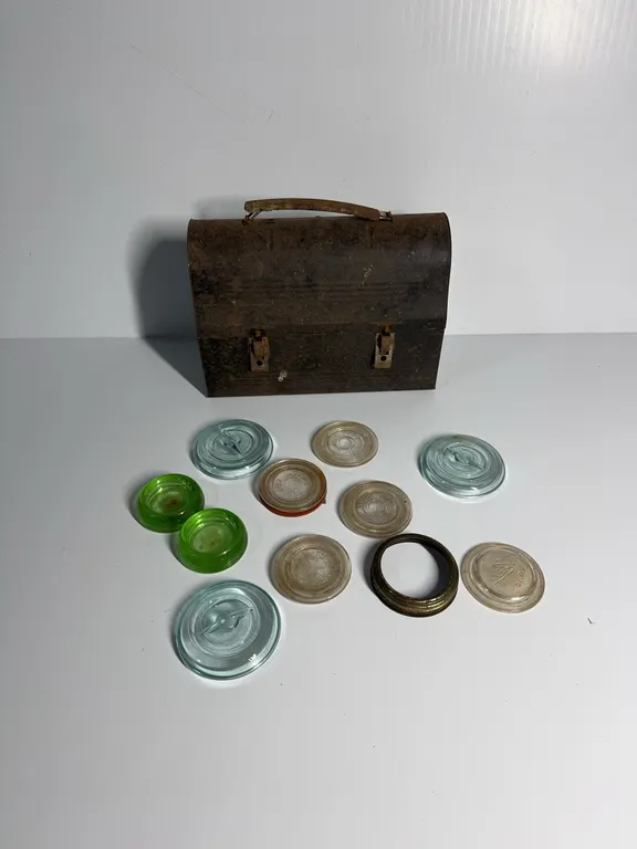 Selection of lids and 2 furniture coasters in vintage lunch box