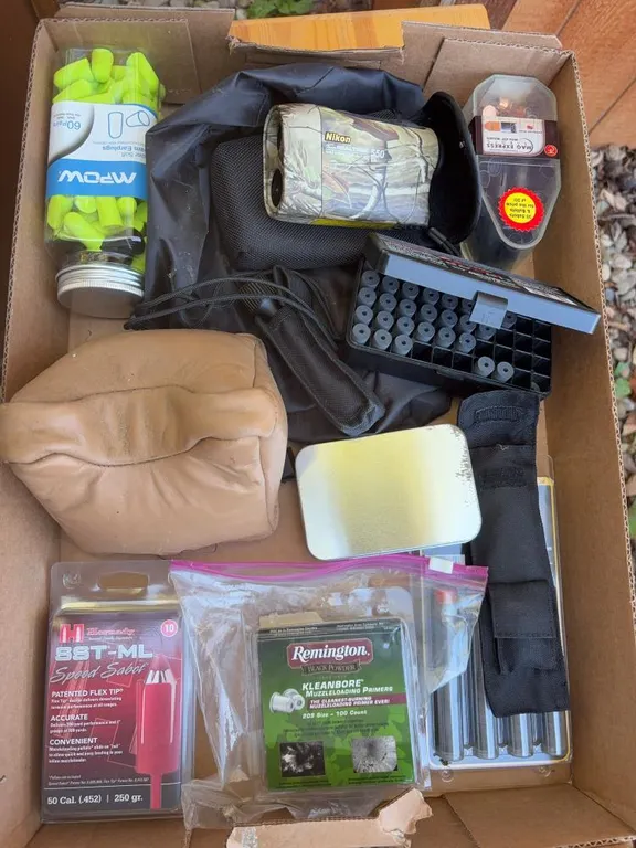 Box of muzzleloader supplies, Nikon 550 rangefinder and more