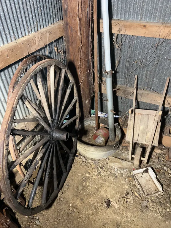 Contents Of Corner Including (2) Wagon Wheels, Wooden Garden Cart & More