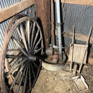 Contents Of Corner Including (2) Wagon Wheels, Wooden Garden Cart & More