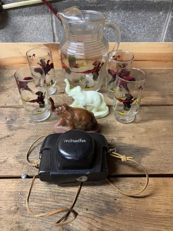 Uranium elephant figurine, water pitcher, water glasses & camera