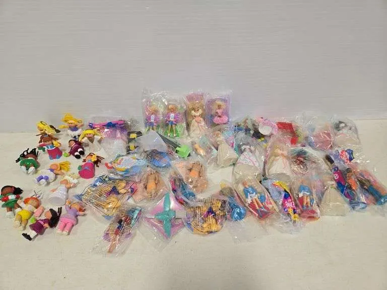 Assortment of McDonald's toys- includes Cabbage Patch & Barbies
