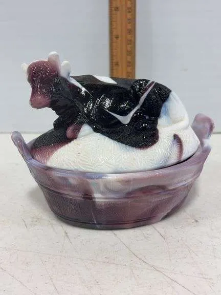 Purple slag glass cow on a nest