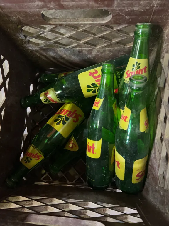 Squirt soda bottles & milk crate