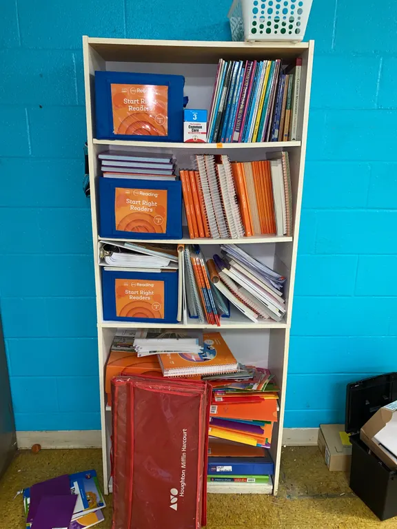 Wooden shelf with books and learning material