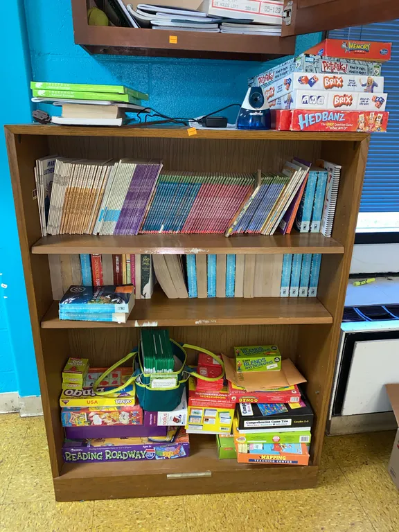 Wooden shelf with board games, books 