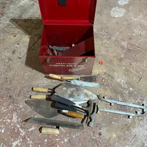 Metal box with mason and concrete tools