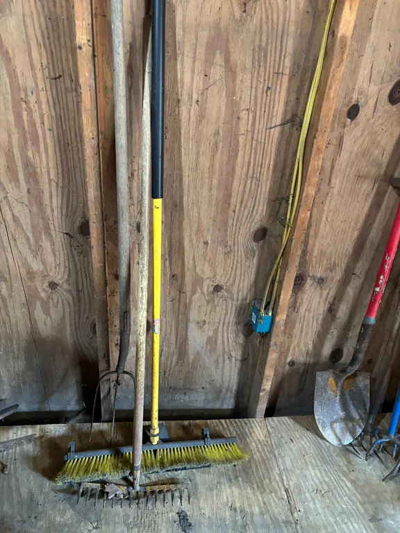 Pitch fork , rake and broom