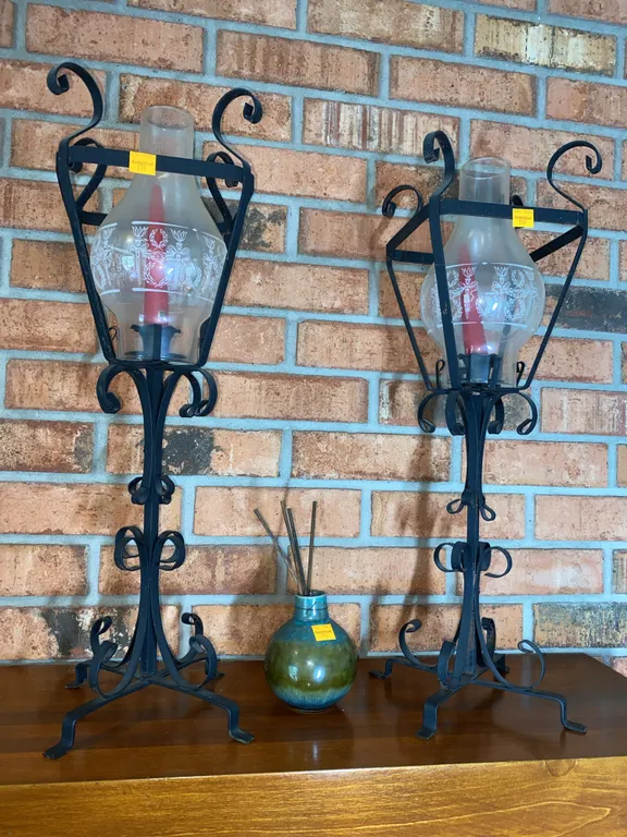 Wrought iron hurricane candle holder with an etched glass globe