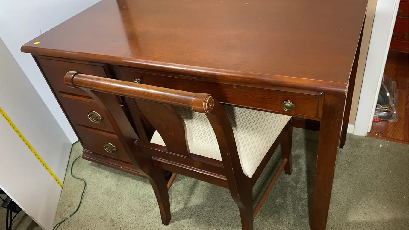 Unmarked wooden desk and chair