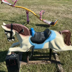 Coin-operated horse ride with black saddle and blue accents